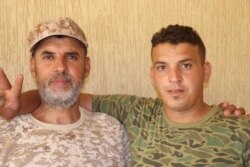 Mohammed Galaw, a commander with the western Tripoli forces, left, with Ali Fateeh Elfegi, right, hours before Ali died on July 7, 2019. (H.Murdock/VOA)