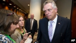 National Governors Association (NGA) Chairman Gov. Terry McAuliffe speaks with reporters after leaving a health care reform meeting during the NGA's Winter Meeting in Washington, Saturday, Feb. 25, 2017.