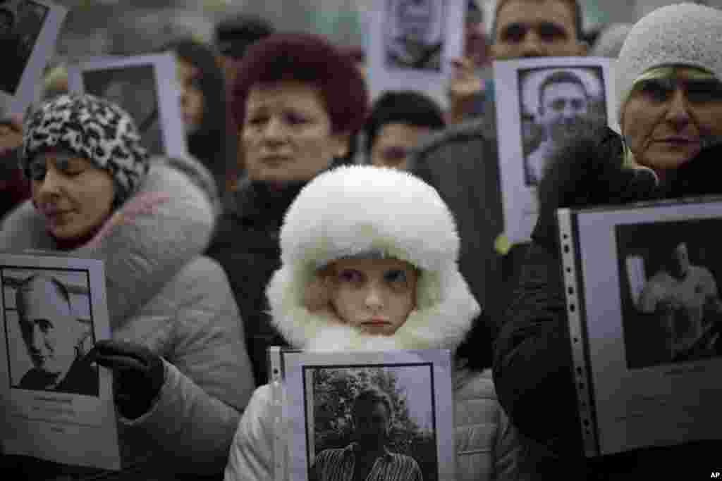 People hold photos of their relatives killed during recent clashes during a rally in Independence Square, Kyiv, Ukraine, March 2, 2014.