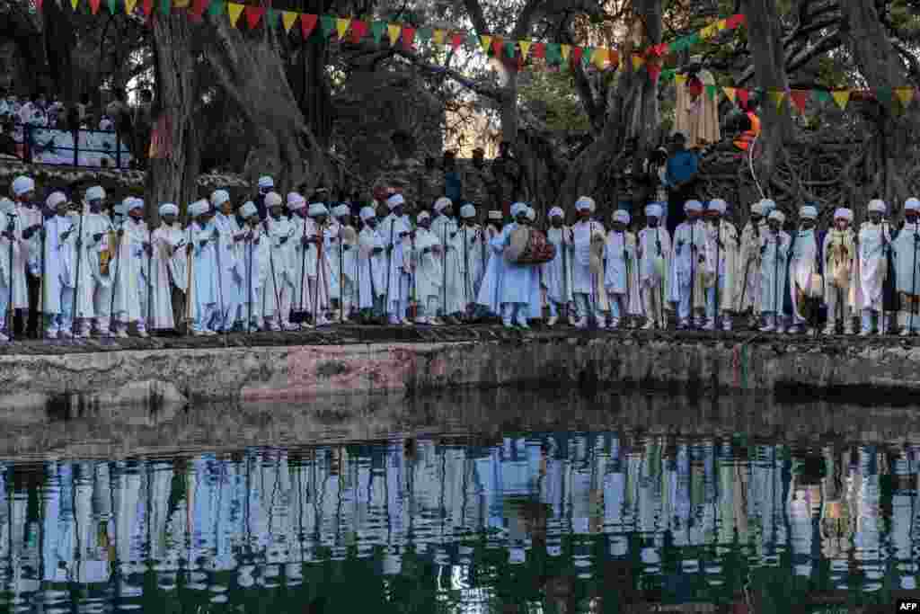 Ethiopian Orthodox Christian priests sing next to the pool of Fasilides Bath during the celebration of Timkat, the Ethiopian Epiphany, in the city of Gondar.