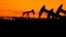 FILE .—Oil pumps work at dusk near Barnes City, Texas, November 1, 2023. A new U.N.-backed study released in November 2023 says major fossil fuel-producing countries plan to extract more than double the amount of such fuels in 2030 than the Paris climate accord recommends. 