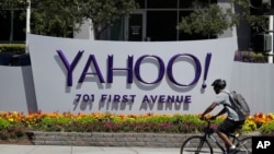 FILE - In this Tuesday, July 19, 2016 file photo, a cyclist rides past a Yahoo sign at the company's headquarters in Sunnyvale, Calif. The Yahoo hack announced Wednesday, Dec. 14, 2016 exposed personal details from more than 1 billion user accounts,…