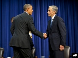President Barack Obama greets John Walsh, U.S. Attorney, District of Colorado, at a White House forum on criminal justice reform, Oct. 22, 2015.