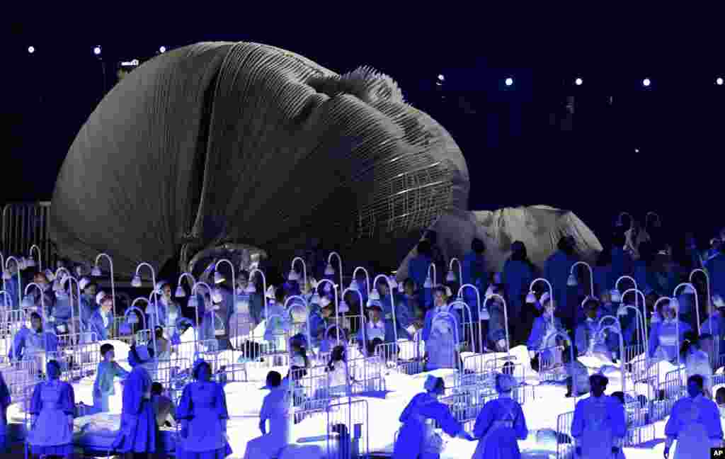 Actors perform in a sequence meant to represent Britain's National Health Service (NHS) perform during the Opening Ceremony at the 2012 Summer Olympics, July 27, 2012, in London. 