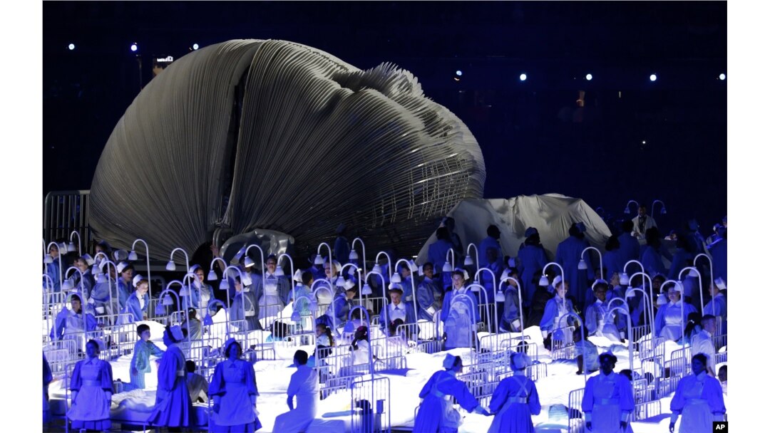 FILE - Actors perform in a sequence meant to represent Britain's National Health Service (NHS) perform during the Opening Ceremony at the 2012 Summer Olympics in London, July 27, 2012.