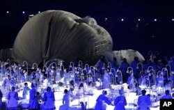 FILE - Actors perform in a sequence meant to represent Britain's National Health Service (NHS) perform during the Opening Ceremony at the 2012 Summer Olympics in London, July 27, 2012.