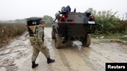 FILE - Turkish soldiers in a military vehicle patrol the Turkish-Syrian border near the village of Hacipasa in Hatay province, Oct. 11, 2012. 