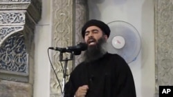 FILE - Image taken from video shows a man purported to be Abu Bakr al-Baghdadi, leader of the Islamic State militant group, delivering a sermon. In an audio recording released late Tuesday, he called on IS fighters in Mosul not to retreat in the face of approaching Iraqi and Kurdish forces.