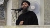 FILE - This image from video posted in July 2014 purports to show Islamic State leader Abu Bakr al-Baghdadi delivering a sermon in Iraq.