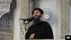 FILE - This image from a 2014 video purports to show Islamic State leader Abu Bakr al-Baghdadi delivering a sermon in Iraq. 