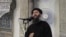 FILE - Image taken from video shows a man purported to be Abu Bakr al-Baghdadi, leader of the Islamic State militant group, delivering a sermon. In an audio recording released late Tuesday, he called on IS fighters in Mosul not to retreat in the face of approaching Iraqi and Kurdish forces.