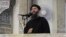 FILE - This still image from video posted on a militant website July 5, 2014, purports to show Islamic State leader Abu Bakr al-Baghdadi delivering a sermon in Iraq.