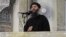 FILE - This image from video posted in July purports to show Islamic State leader Abu Bakr al-Baghdadi delivering a sermon in Iraq, July 5, 2014. Islamic State media has announced the death of the leader's son.