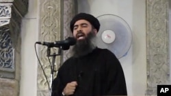 FILE - This image from video posted in July purports to show Islamic State leader Abu Bakr al-Baghdadi delivering a sermon in Iraq; he's said to have been wounded with beheadings suspect "Jihadi John" in an airstrike last Saturday.