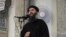 FILE - This image from video posted in July purports to show Islamic State leader Abu Bakr al-Baghdadi delivering a sermon in Iraq; he's said to have been wounded with beheadings suspect "Jihadi John" in an airstrike last Saturday.