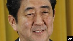 Japan's Liberal Democratic Party President Shinzo Abe smiles during a question and answer during a press conference at the party headquarters in Tokyo, December 17, 2012.