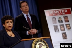 FILE - U.S. Attorney General Loretta Lynch and FBI Director James Comey hold a news conference to announce indictments on Iranian hackers for a coordinated campaign of cyber attacks on several U.S. banks and a New York dam, at the Justice Department in Washington, March 24, 2016.