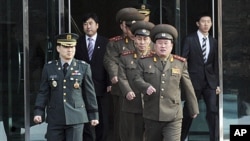 North Korean Colonel Ri Son-kwon (front R) and other North Korean officers walk south of the truce village of Panmunjom in Paju, north of Seoul, February 8, 2011