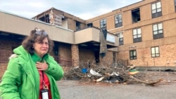 Judy Burton becomes emotional while standing outside her apartment building, which was severely damaged in Friday's tornados, in Mayfield, Ky., Sunday, Dec. 12, 2021. (AP Photo/Claire Galofaro)