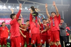Vietnam's soccer team celebrates after defeating Malaysia at the AFF Suzuki Cup final match between Vietnam and Malaysia at My Dinh stadium in Hanoi, Vietnam on Saturday, Dec. 15, 2018.