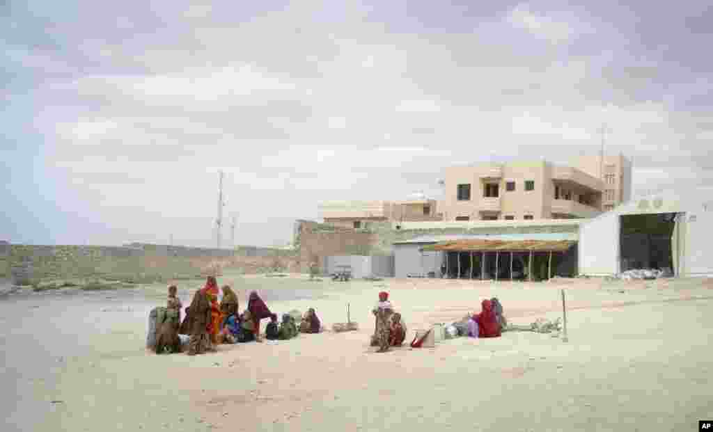 SOMALIA: Refugees wait at an almost deserted feeding site run by the Somali aid agency Jumbo Peace and Development Organization which cooks food provided by the World Food Program. AP photo taken on Feb. 15, 2012 during investigation of stolen food aid by the news agency. 