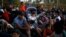 Migrants, part of a caravan travelling to the U.S., gather near the border between Guatemala and Mexico, in Tecun Uman, Guatemala, Jan. 20, 2020.