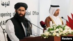 Muhammad Naeem (L), a spokesman for the Office of the Taliban of Afghanistan speaks during the opening of the Taliban Afghanistan Political Office in Doha, June 18, 2013. 