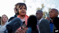 Winnie Madikizela-Mandela addresses the media in front the house of her former husband and former South African President Nelson Mandela in Soweto, June 28, 2013. 