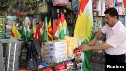 FILE - A Kurdish man sells flags of the semi-autonomous region of Kurdistan in his shop in Arbil, 310 km (193 miles) north of Baghdad, August 30, 2009.
