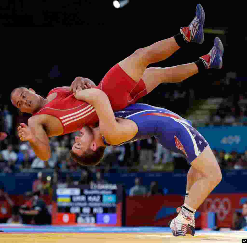 Keitani Graham of Micronesia competes against Charles Edward Betts of the United States, right, during the 84-kg Greco-Roman wrestling competition.