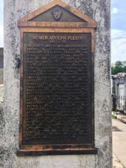 FILE - This June 3, 2018 photo shows a marker on the burial site for Homer Plessy in New Orleans.