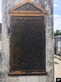 FILE - This June 3, 2018 photo shows a marker on the burial site for Homer Plessy in New Orleans.