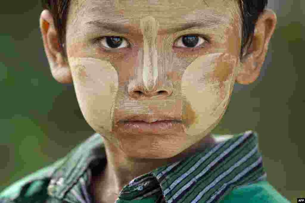 A Myanmar boy wearing the traditional sun protection thanaka facial paste is seen at Tat Kone in the outskirts of the capital city of Naypyidaw, Oct. 28, 2015.