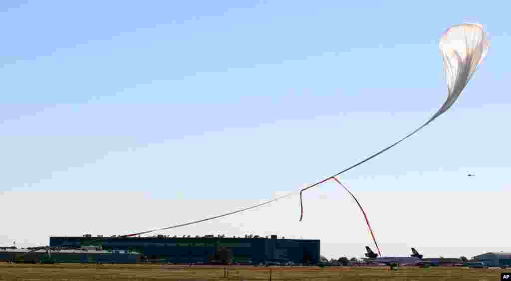 The capsule and attached helium balloon carrying Baumgartner lifts off from Roswell, N.M.