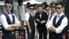 FILE - Ling Jueding (C) poses for a photo with his best men before his wedding ceremony at a park in Beijing, June 27, 2015.