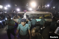 FILE - An ambulance carrying the body of Salauddin Quader Chowdhury, a leader of the Bangladesh Nationalist Party, leaves the Dhaka Central Jail after his execution, Nov. 22, 2015.