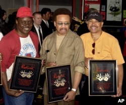 FILE - From left, Philip Bailey, Maurice White and Ralph Johnson of Earth Wind & Fire are inducted at the Hollywood Rock Walk in Los Angeles, July 7, 2003. White died at home in Los Angeles Feb. 3, 2016.