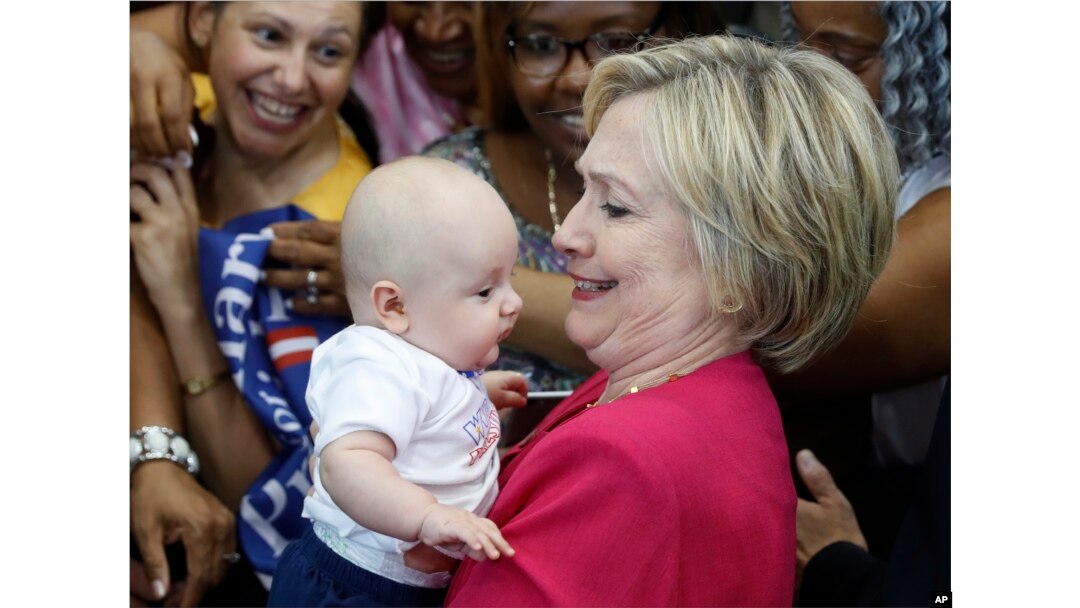 Democratic presidential candidate Hillary Clinton holds a baby as she greets people in the audience at a Pennsylvania Democratic Party voter registration event at West Philadelphia High School in Philadelphia, Aug. 16, 2016.
