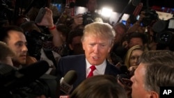 Republican presidential candidate Donald Trump speaks to the media in the spin room after the first Republican presidential debate at the Quicken Loans Arena, Aug. 6, 2015, in Cleveland. 