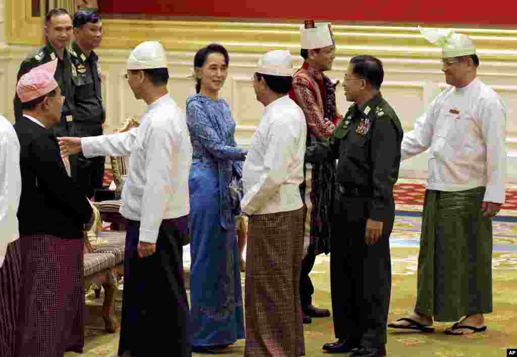 Aung San Suu Kyi, center, shakes hands with Senior General Min Aung Hlaing after the presidential handover ceremony in Naypyitaw, Myanmar, Wednesday, March 30, 2016.