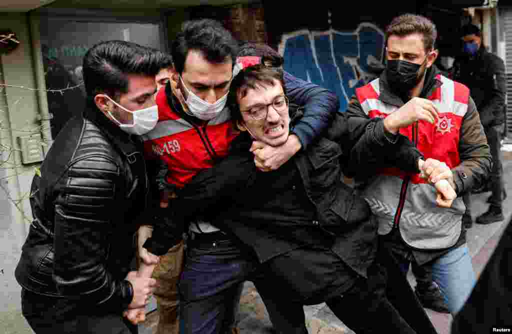 Police officers detain a demonstrator during a protest against the appointment of a rector by President Tayyip Erdogan in Istanbul, Turkey.