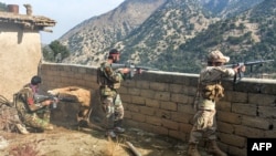 FILE - Afghan security forces take part in an ongoing operation against Islamic State militants in the Achin district of Nangarhar province, Nov. 25, 2019.