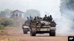 Congolese government troops ride armored vehicles toward the front line, near the eastern city of Goma, Democratic Republic of Congo, July 17, 2013. 