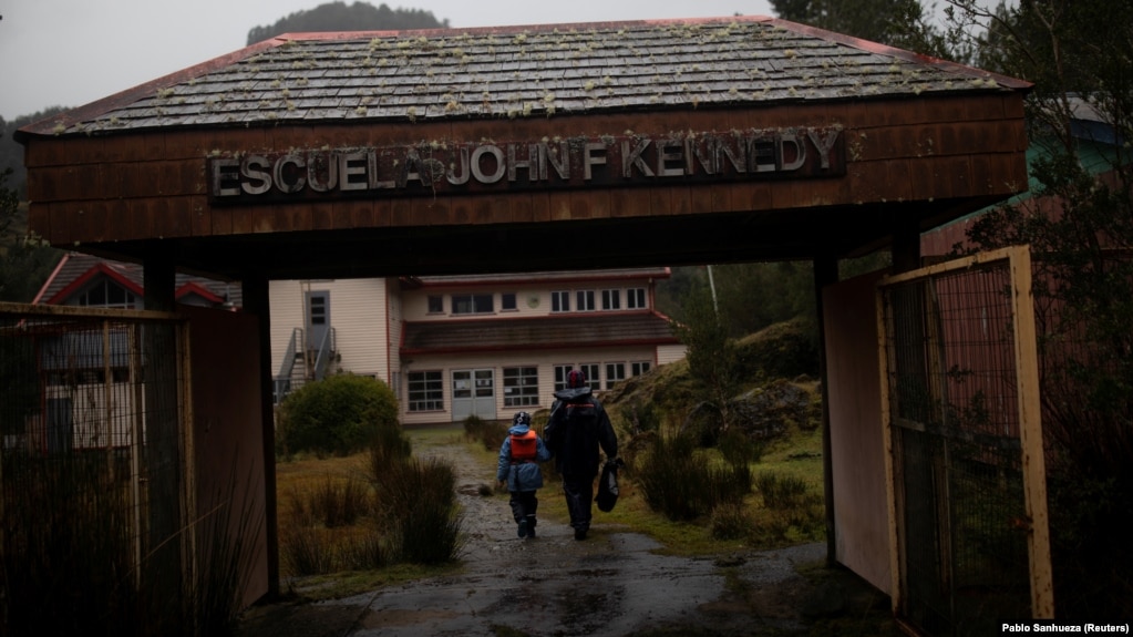 Carlos Guerrero, 40, with his son Diego, 7, arrive at John F Kennedy School in the village of Sotomo, outside the town of Cochamo, Los Lagos region, Chile, August 6, 2021. (REUTERS/Pablo Sanhueza)