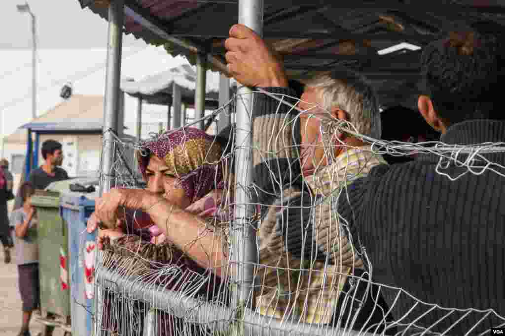 People wait in line for food at Idomeni camp. Conditions are harsh, but for many it the lack of information that is most frustrating, April 22, 2016. (J. Owens/VOA)