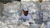 A worker organizes humanitarian aid for Venezuela at a warehouse near the Tienditas cross-border bridge between Colombia and Venezuela in Cucuta, Colombia, Feb. 8, 2019.