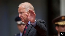 U.S. Vice President Joe Biden waves to photographers at the National Palace in Guatemala City, June 20, 2014.