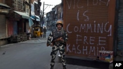 An Indian paramilitary soldier stands guard during curfew in Srinagar, Indian controlled Kashmir, Sept. 13, 2016.