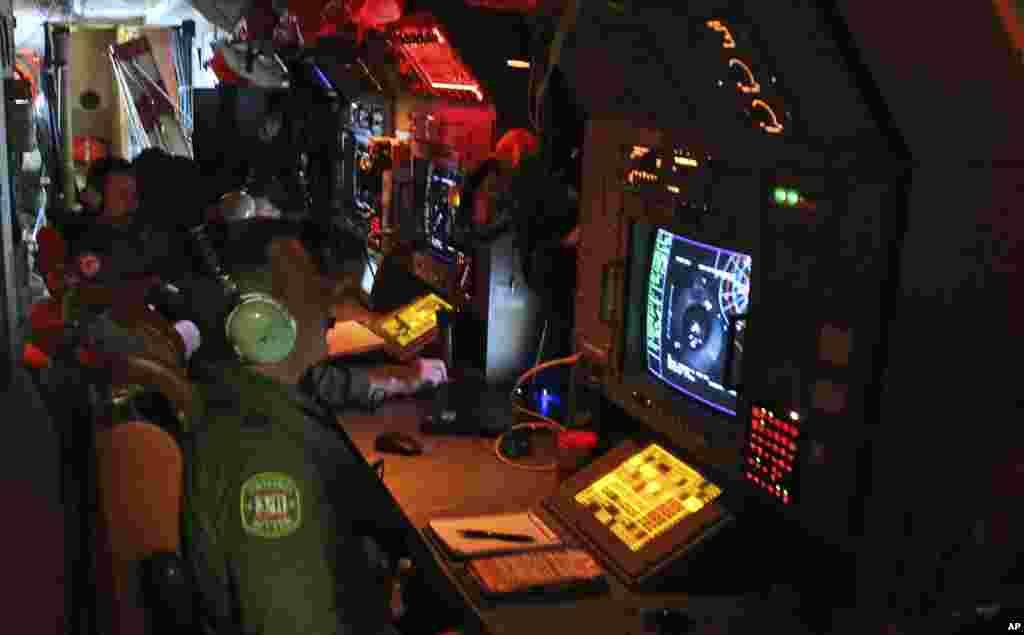 Australian aircrew members man radars and sonar as they search for flight MH370 in the southern Indian Ocean, March 22, 2014.