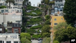 Cars wind their way down Lombard Street in San Francisco, April 15, 2019. Thousands of tourists may soon have to pay as much as $10 to drive down the world-famous crooked street if a proposal to establish a toll and reservation system becomes law. (AP Photo/Eric Risberg)